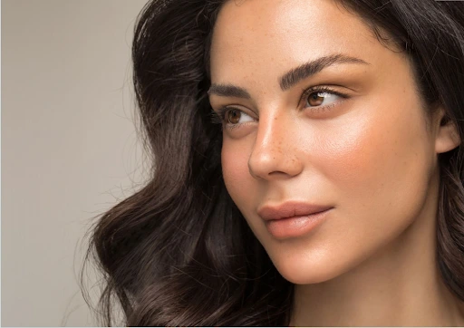 Woman with defined eyebrows and smooth skin representing VectorLift® non-surgical laser eyebrow lift treatment.
